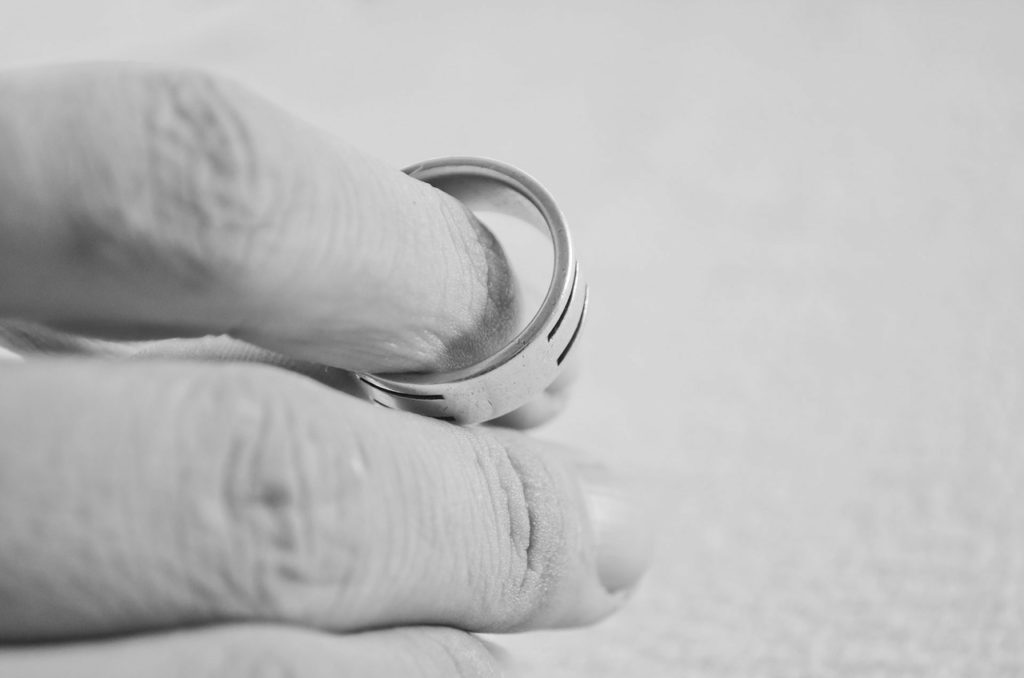 Hand holding a ring as courts decide who owns it after divorce