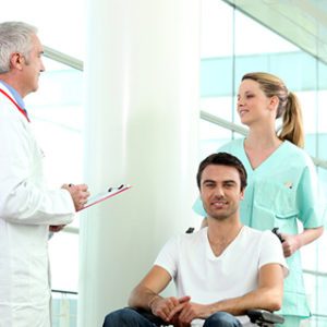 Man in a wheelchair with nurse and doctor