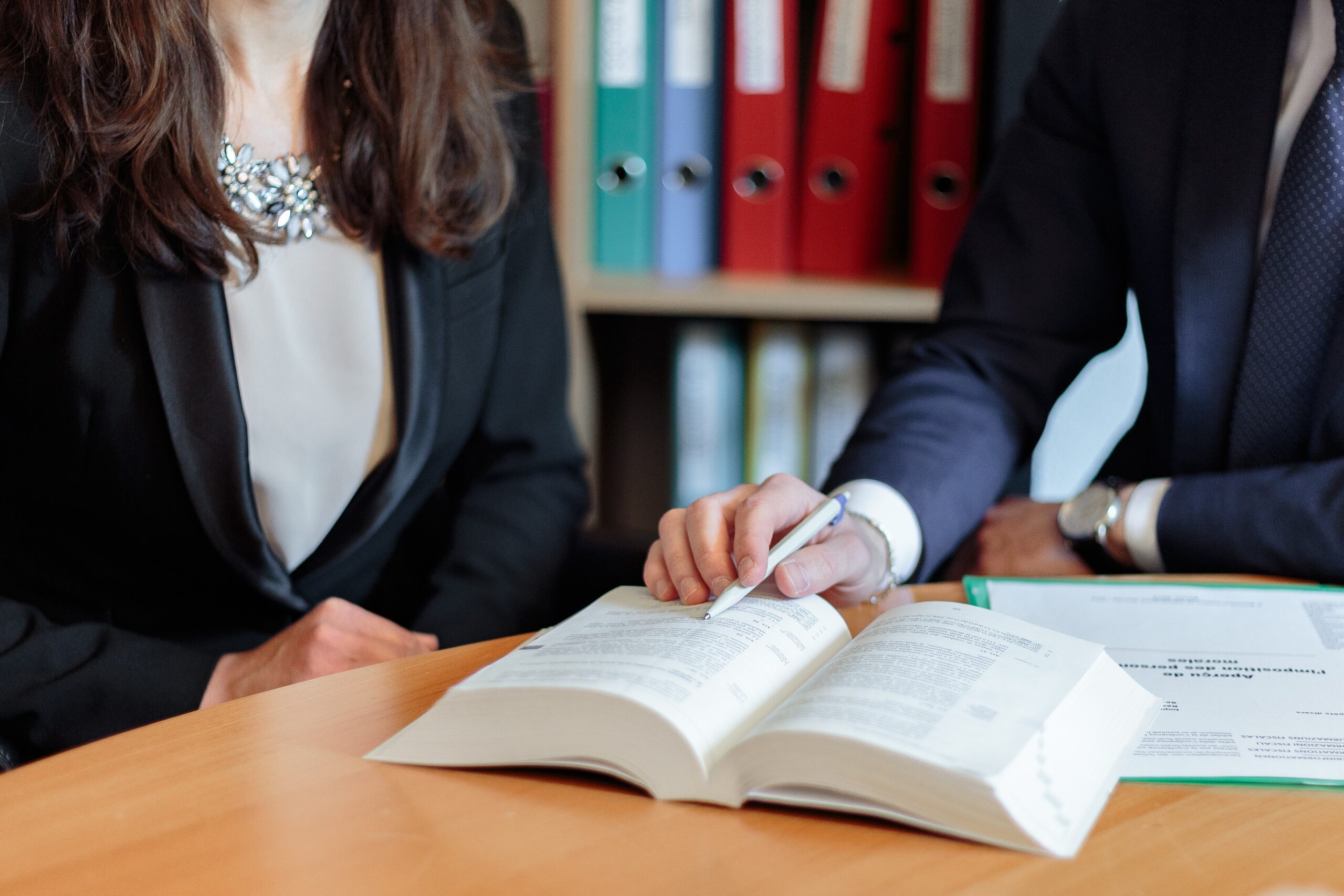 Lawyer pointing at a specific part of a book